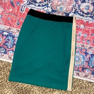 Green bandage pencil skirt with black tan accent and gold exposed zipper